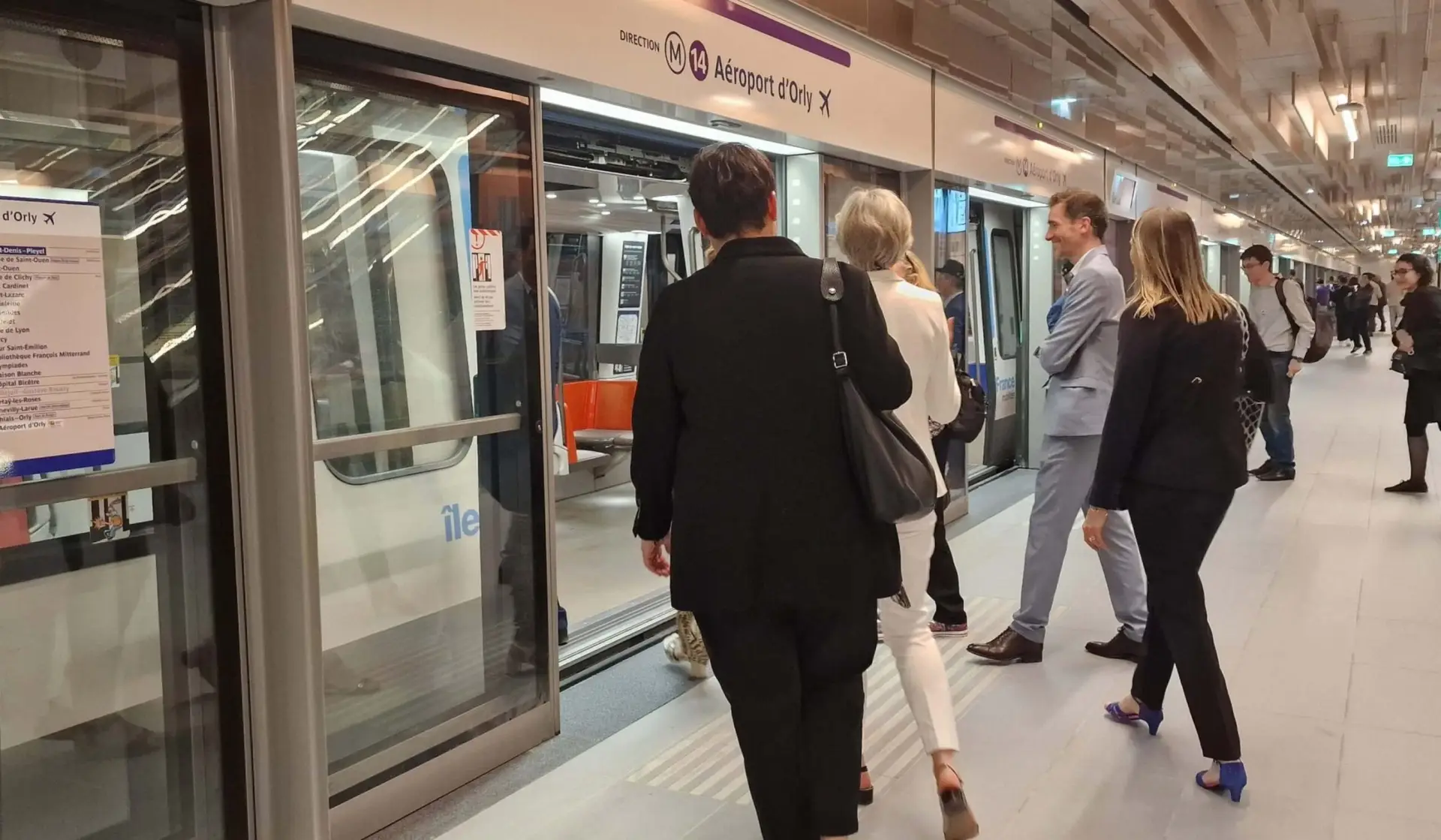 Passengers boarding Paris Metro Line 14 train at Aeroport d'Orly station illustrating setec consulting engineers international metro and urban transport infrastructure engineering expertise
