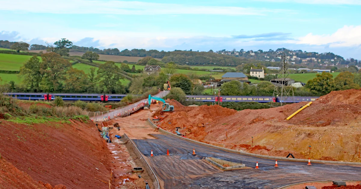 Railway earthworks construction site with excavated ground and machinery, highlighting the importance of railway ground investigations.