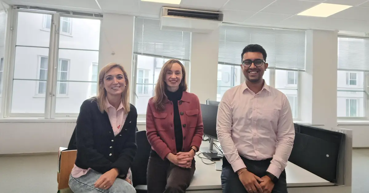 Three setec colleagues wearing pink clothing in the office to support Breast Cancer Awareness Month 2026.